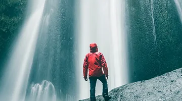 Man infrond of waterfall